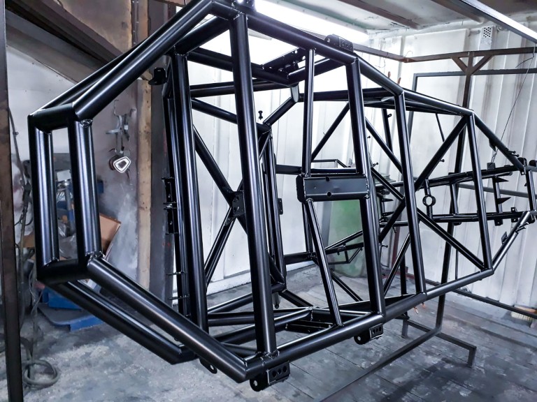 Large chassis in house powder coated in black.
